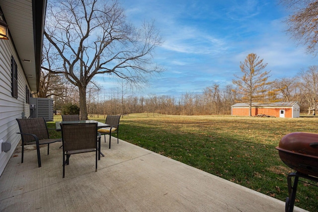 view of patio featuring central AC unit and a storage shed