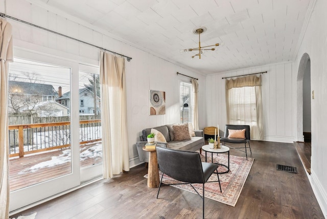 living room featuring crown molding and dark hardwood / wood-style flooring