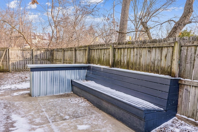 snow covered pool featuring a patio area