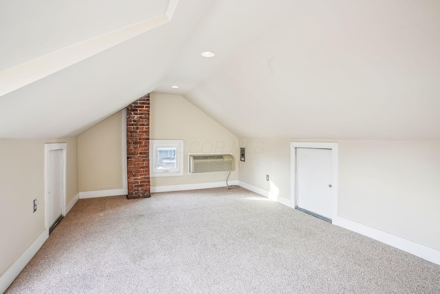 bonus room featuring vaulted ceiling, carpet, and a wall unit AC