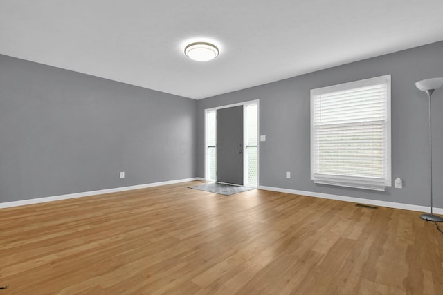 spare room featuring light hardwood / wood-style flooring