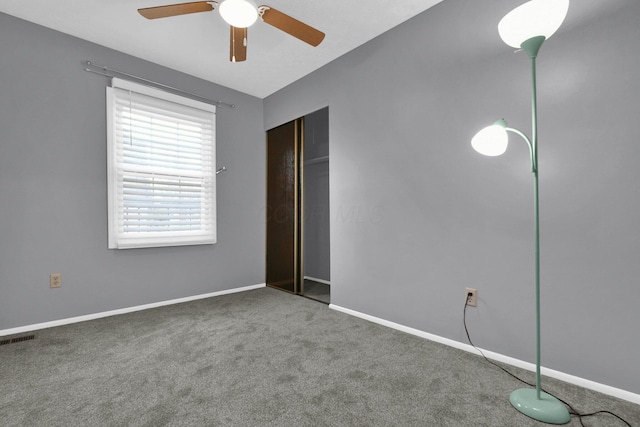 unfurnished bedroom with ceiling fan, a closet, and carpet