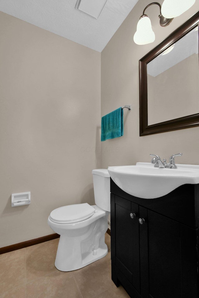 bathroom featuring toilet, tile patterned floors, and vanity