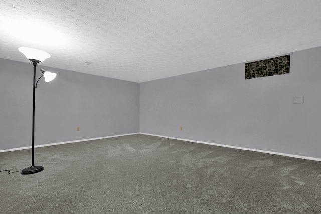 interior space featuring a textured ceiling and dark colored carpet