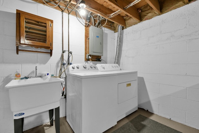 washroom with electric panel, sink, and independent washer and dryer