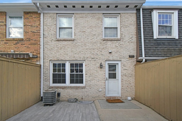 back of house featuring cooling unit