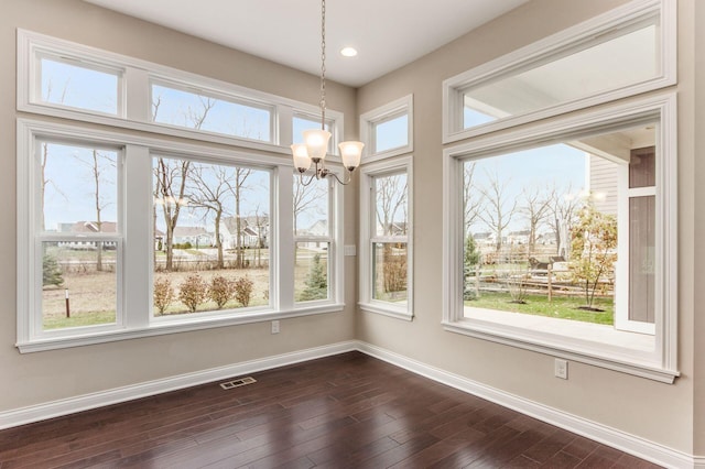 unfurnished sunroom featuring a notable chandelier