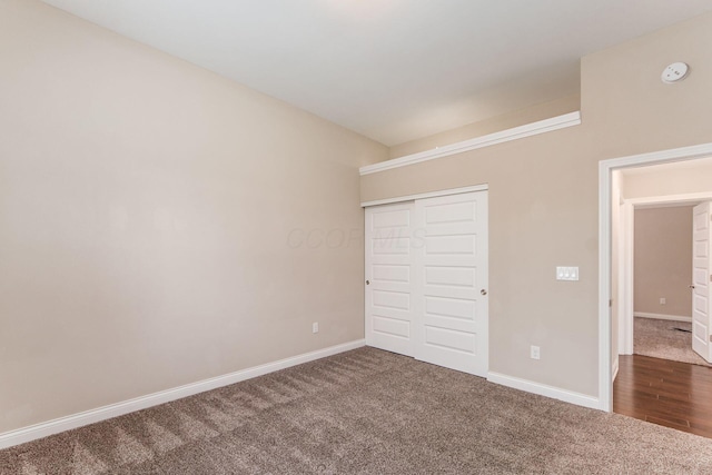 unfurnished bedroom with carpet flooring and a closet