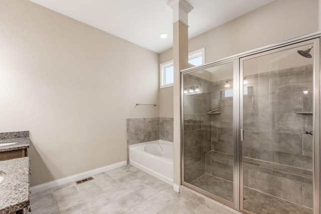 bathroom with vanity and shower with separate bathtub