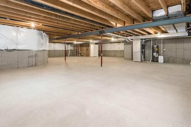 basement with electric water heater and heating unit