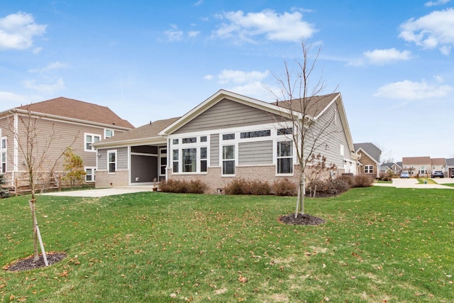 rear view of property with a yard and a patio