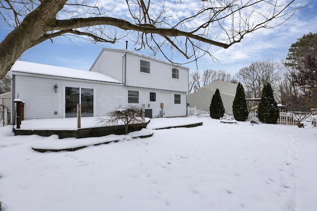 view of snow covered rear of property