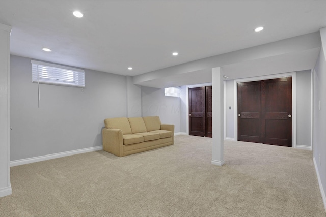 basement featuring light carpet