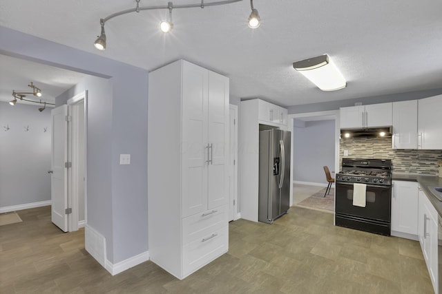 kitchen with black range with gas cooktop, stainless steel fridge with ice dispenser, a textured ceiling, white cabinetry, and tasteful backsplash