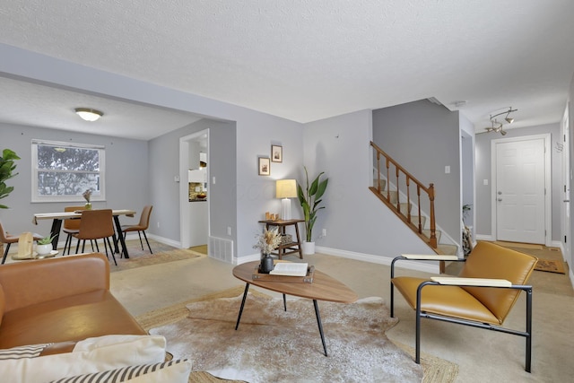 living room with light colored carpet and a textured ceiling