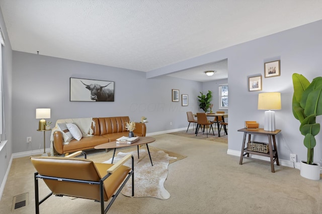 living room with beamed ceiling and light carpet