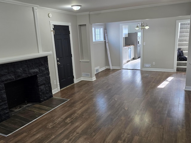 unfurnished living room featuring crown molding, dark wood-type flooring, a chandelier, and a fireplace