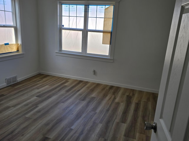 unfurnished room featuring dark hardwood / wood-style flooring