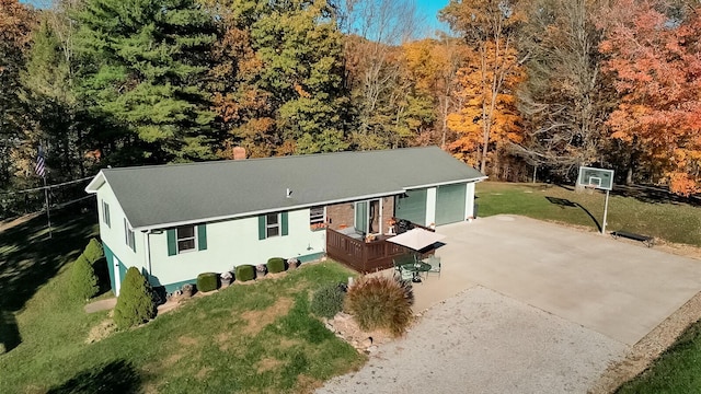 single story home featuring a front lawn and a deck