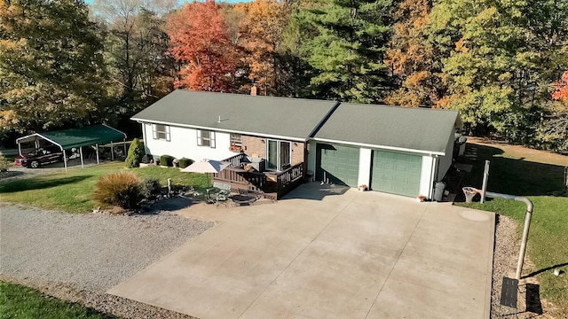 view of front of property with a front lawn, a garage, and a carport