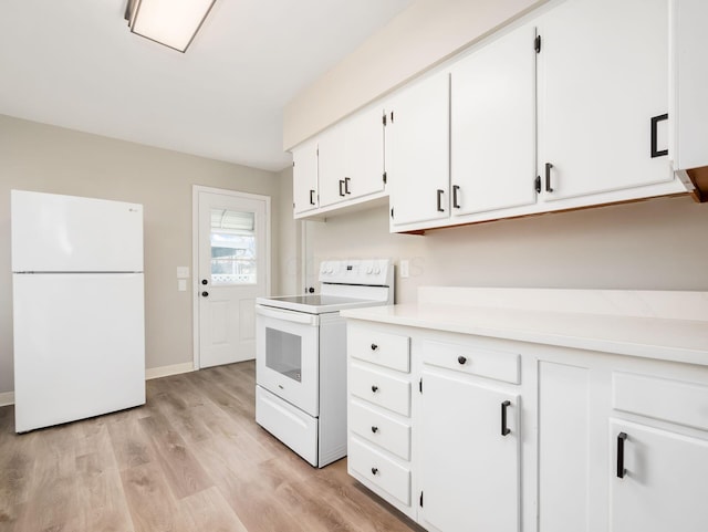 kitchen with white appliances, white cabinetry, and light wood-type flooring