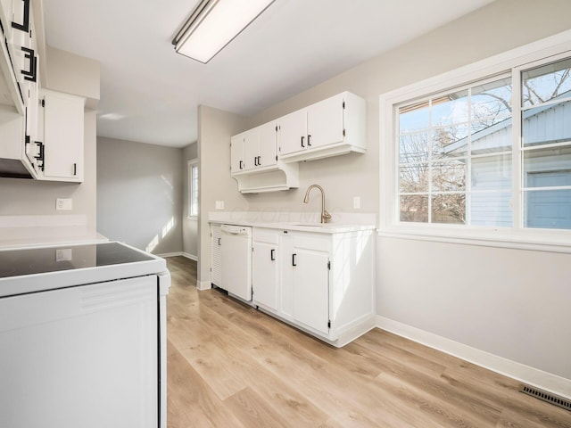 kitchen featuring sink, white appliances, light hardwood / wood-style floors, and white cabinets