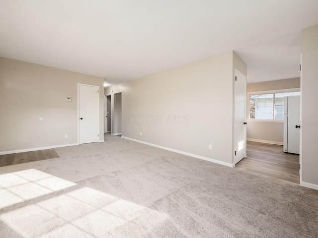 empty room featuring light colored carpet