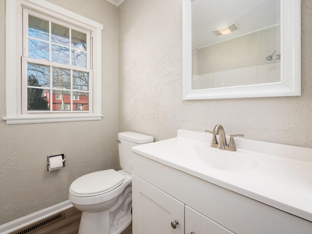 bathroom featuring toilet, hardwood / wood-style flooring, and vanity