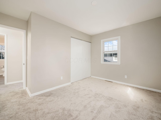 unfurnished bedroom featuring a closet and carpet