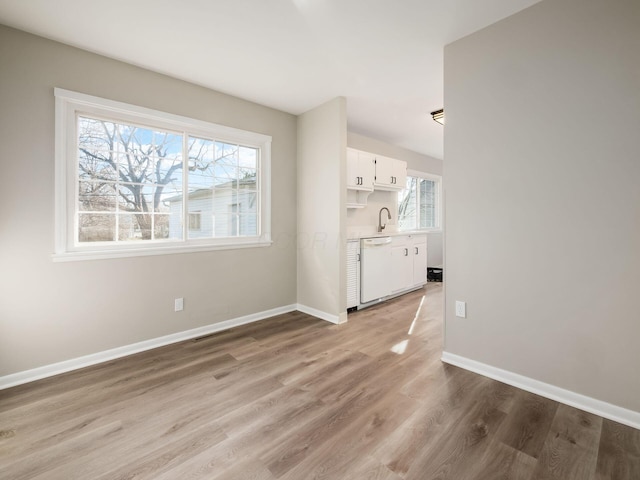 interior space featuring sink and light hardwood / wood-style flooring