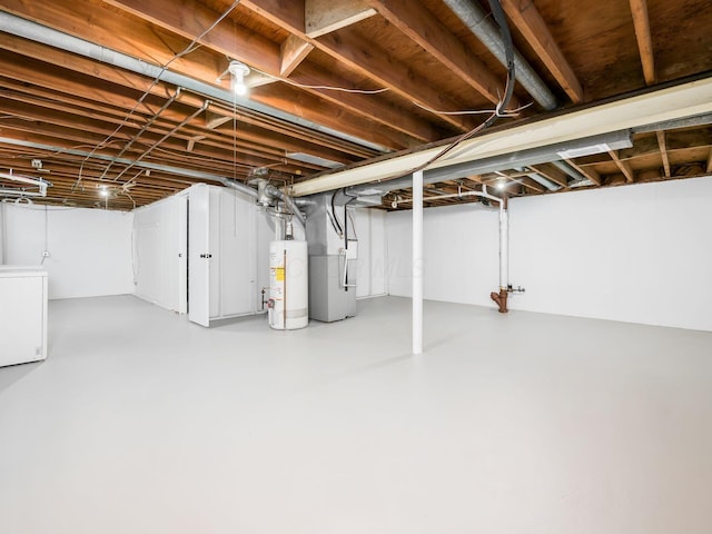 basement with washer / dryer, heating unit, and gas water heater