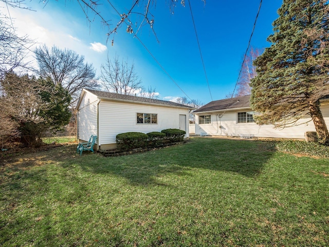 rear view of property with a yard