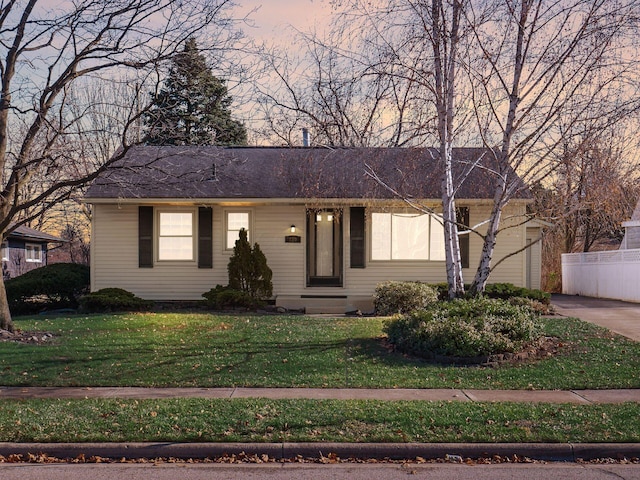 ranch-style home featuring a lawn