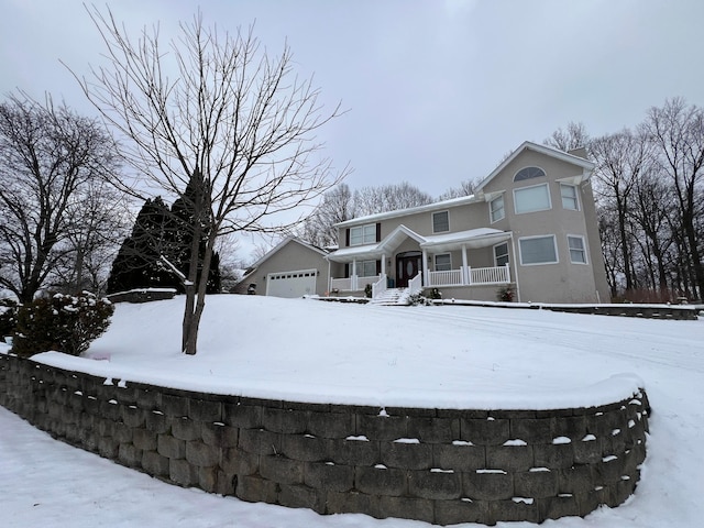 exterior space with an outbuilding, covered porch, and a garage