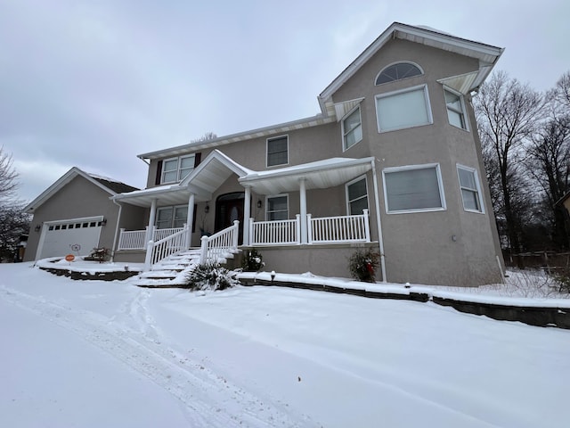 view of front of house featuring a porch and a garage