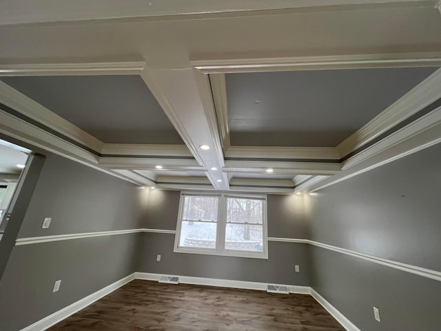 spare room with hardwood / wood-style floors, beam ceiling, ornamental molding, and coffered ceiling