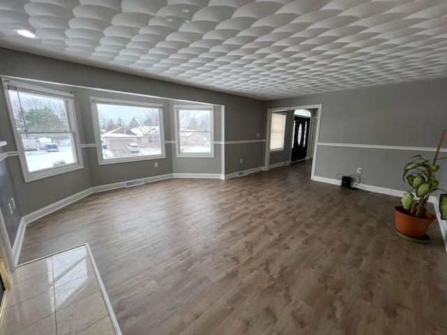 unfurnished living room with wood-type flooring