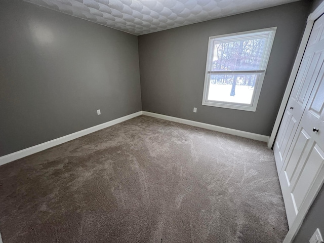 empty room with carpet flooring