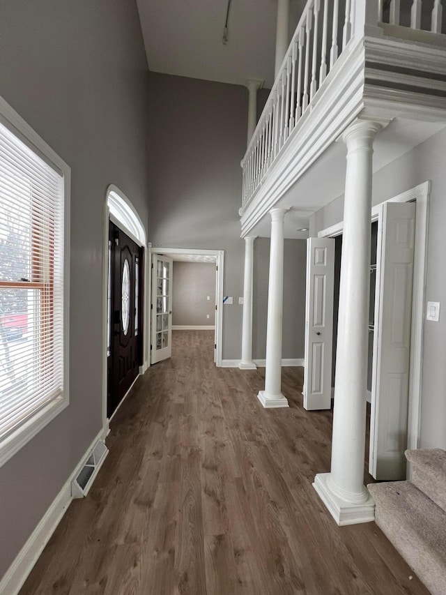 entrance foyer featuring dark wood-type flooring and a high ceiling