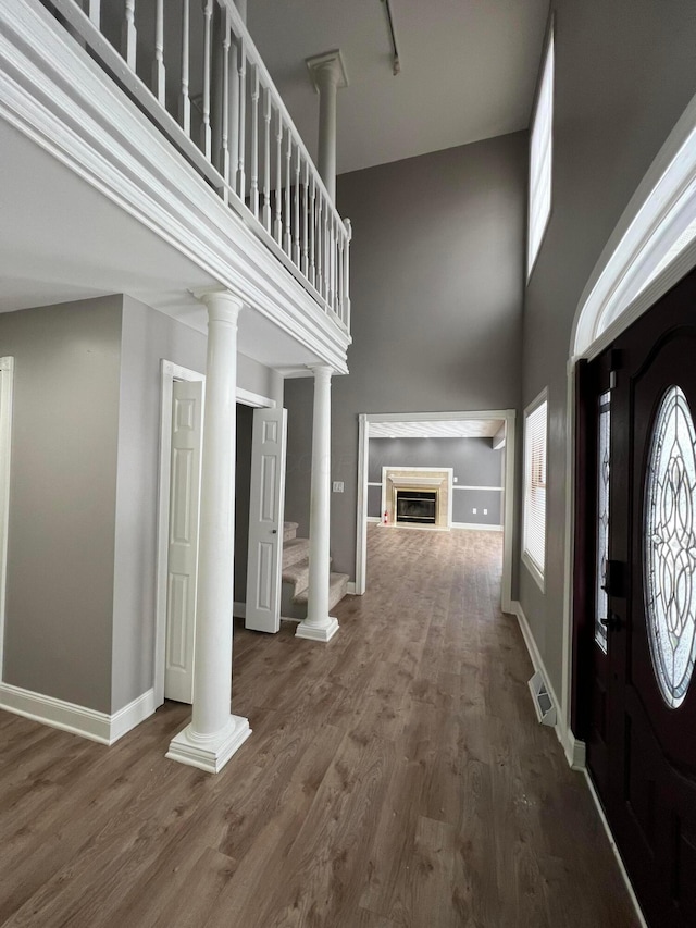 entrance foyer featuring wood-type flooring and a high ceiling