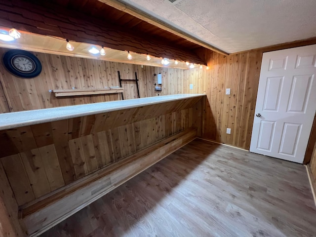 bar featuring wood walls and wood-type flooring