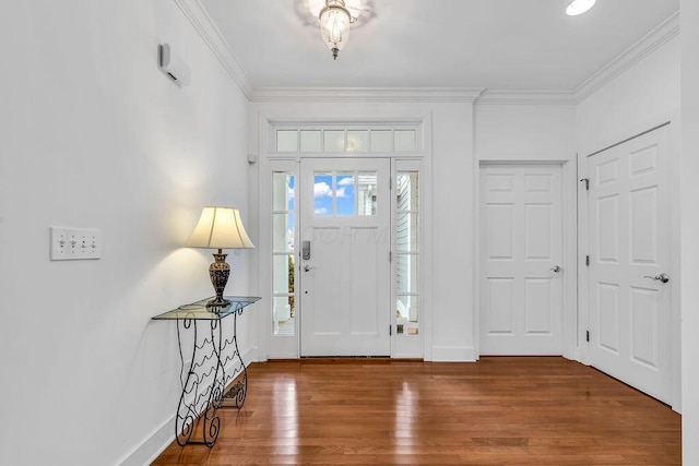 entrance foyer with hardwood / wood-style floors and crown molding