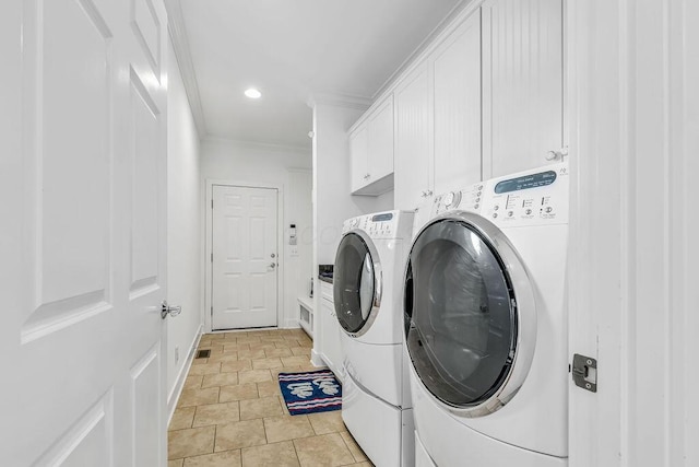 washroom with cabinets, separate washer and dryer, ornamental molding, and light tile patterned floors