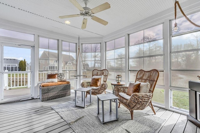 sunroom / solarium featuring ceiling fan