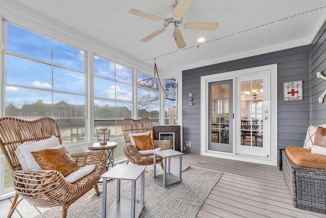 sunroom / solarium featuring plenty of natural light and ceiling fan