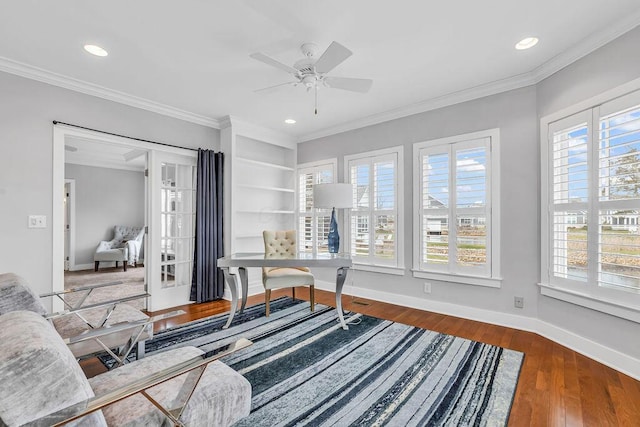 office area featuring built in shelves, ceiling fan, dark hardwood / wood-style flooring, and ornamental molding