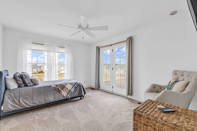 carpeted bedroom with access to outside, multiple windows, and ceiling fan