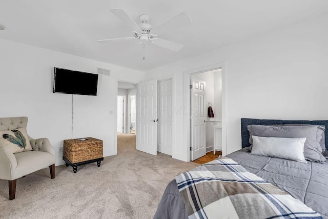 carpeted bedroom featuring ensuite bathroom and ceiling fan