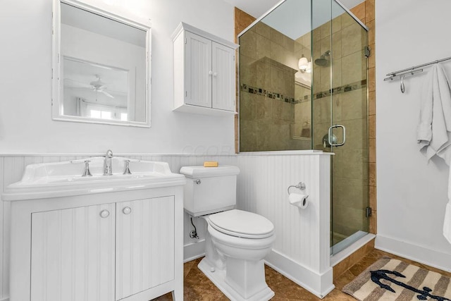 bathroom featuring tile patterned floors, ceiling fan, a shower with shower door, and toilet