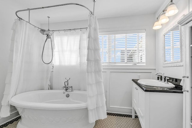 bathroom with vanity and a bath